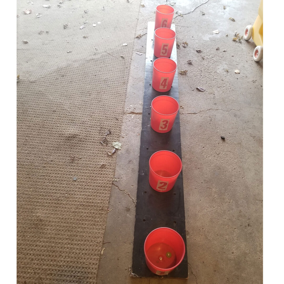Small orange buckets with numbers
