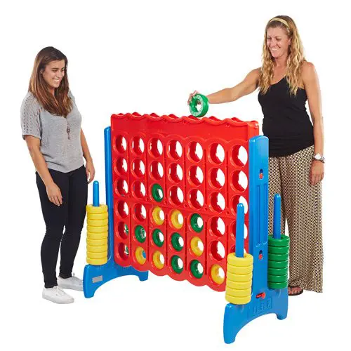Two women playing Giant Connect 4